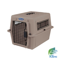 The Petmate Traveler - Ultra Vari Kennel is a beige plastic pet carrier with a metal wire door, side vents, and the Petmate logo on top; an EcoTEC Plastic emblem appears in the bottom right corner.