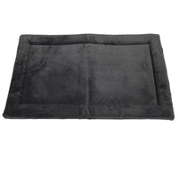 The Petmate Kennel Mat by Petmate is a rectangular, dark grey pet bed with a soft velvety texture and non-skid bottom, featuring a raised border and plush flat center like a mattress, ensuring it offers comfort for small to medium-sized pets while staying in place.