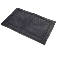 The Petmate Kennel Mat is a soft, rectangular, dark gray pet bed with a plush mattress and slightly raised edges. Its non-skid bottom ensures comfort and security for your furry friend. It sits elegantly on a white background.
