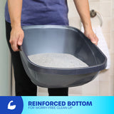 Person holding a gray Petmate Basic Hooded Cat Litter Pan, filled with litter. Text reads, Reinforced Bottom for Worry-Free Clean Up, next to a flexed arm icon. Background features a towel on a hook and an odor-absorbing filter for easy cleaning. Brand: Petmate.