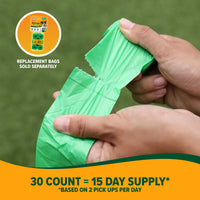 A close-up shows hands tearing a green Arm & Hammer Cornstarch Waste Bag from a roll in the grass. An inset highlights Replacement bags sold separately. Footer reads, 30 count = 15 day supply* *Based on 2 pick-ups per day. Ideal choice for eco-friendly pet supplies.