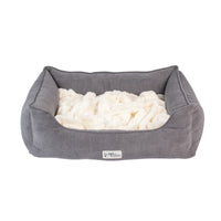 The gray PetFusion Calming Cuddler Dog Bed has raised edges and a plush cream interior for dog anxiety relief, featuring a front label with the Pet Fusion logo to showcase it as a trusted brand.