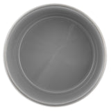 A top view of an empty, round gray ceramic bowl with a smooth, glossy surface complements any kitchen decor when paired with Petmate Painted Stainless Steel Pet Bowls by the brand Petmate.