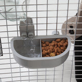 The Petmate No Spill Kennel Cup Double Diner by Petmate attaches to pet cage bars, featuring a dual feeder with one section for water from a connected bottle and another for kibble. Its BPA and lead-free, ensuring your pets safety.