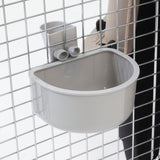 The Petmate No Spill Kennel Cup, in beige, mounts securely to a metal wire cage with square openings using a sturdy bracket. This rounded rectangular bowl from Petmate is perfect for pets and provides convenience as an efficient travel water bowl.
