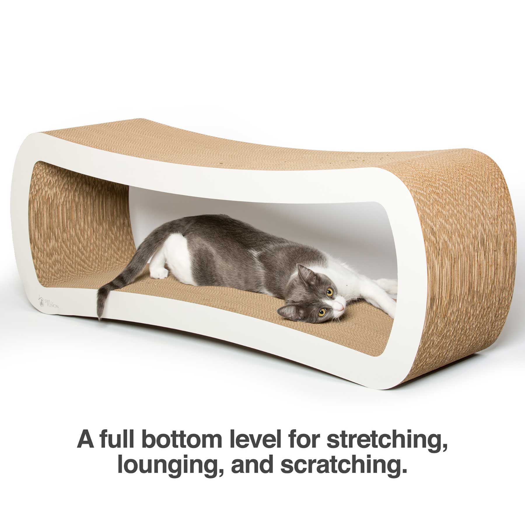 A gray and white cat relaxes in the PetFusion Jumbo Cat Scratcher Lounge by Pet Fusion, a chic piece of pet furniture. This cardboard scratcher includes a curved design ideal for scratching, stretching, and lounging. Text below the image highlights these features.