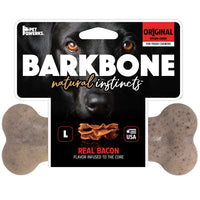 The BarkBone Natural Instincts Bacon-Infused Nylon Dog Chew packaging showcases durable chews for tough chewers. Real Bacon Flavor-Infused to the Core highlights the packs bottom, adorned with a lively dog image and bacon pieces illustration in the background.