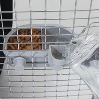 The Petmate No Spill Kennel Cup Double Diner provides hydration and nourishment to pets in metal cages, featuring a water pitcher for easy filling and a feeding tray for brown pet food. This setup ensures pets stay nourished and hydrated on the go with BPA and lead-free materials.