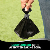 A hand holds an Arm & Hammer MAX Blackout Dog Waste Bag against a grassy backdrop. Text below reads, Odor Control with Activated Baking Soda.