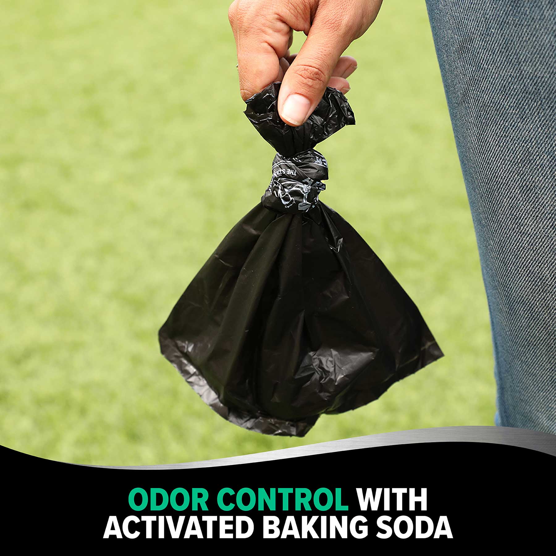 A hand holds an Arm & Hammer MAX Blackout Dog Waste Bag against a grassy backdrop. Text below reads, Odor Control with Activated Baking Soda.